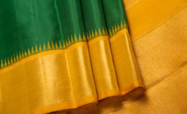 dark green saree with yellow border